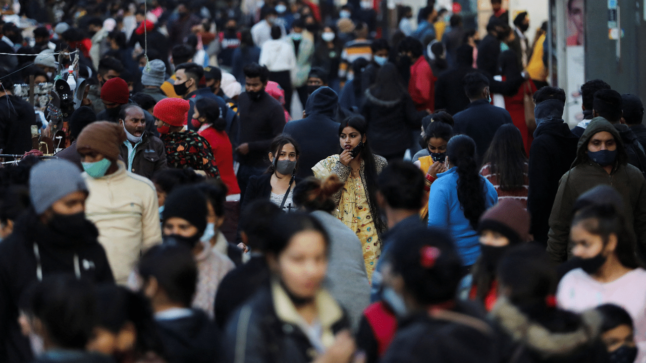 People shop at a market amidst the spread of coronavirus disease in New Delhi. Credit: Reuters Photo
