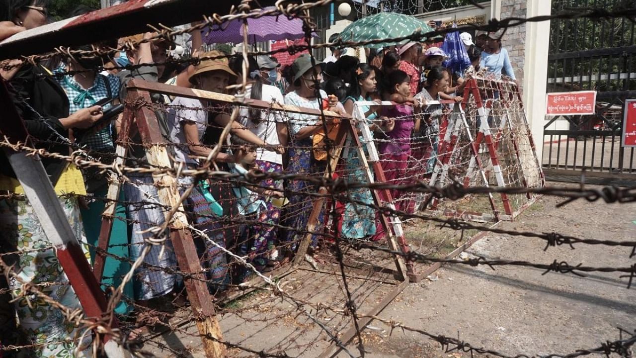 Relatives wait in front of the Insein Prison for the release of prisoners in Yangon. Credit: AFP Photo