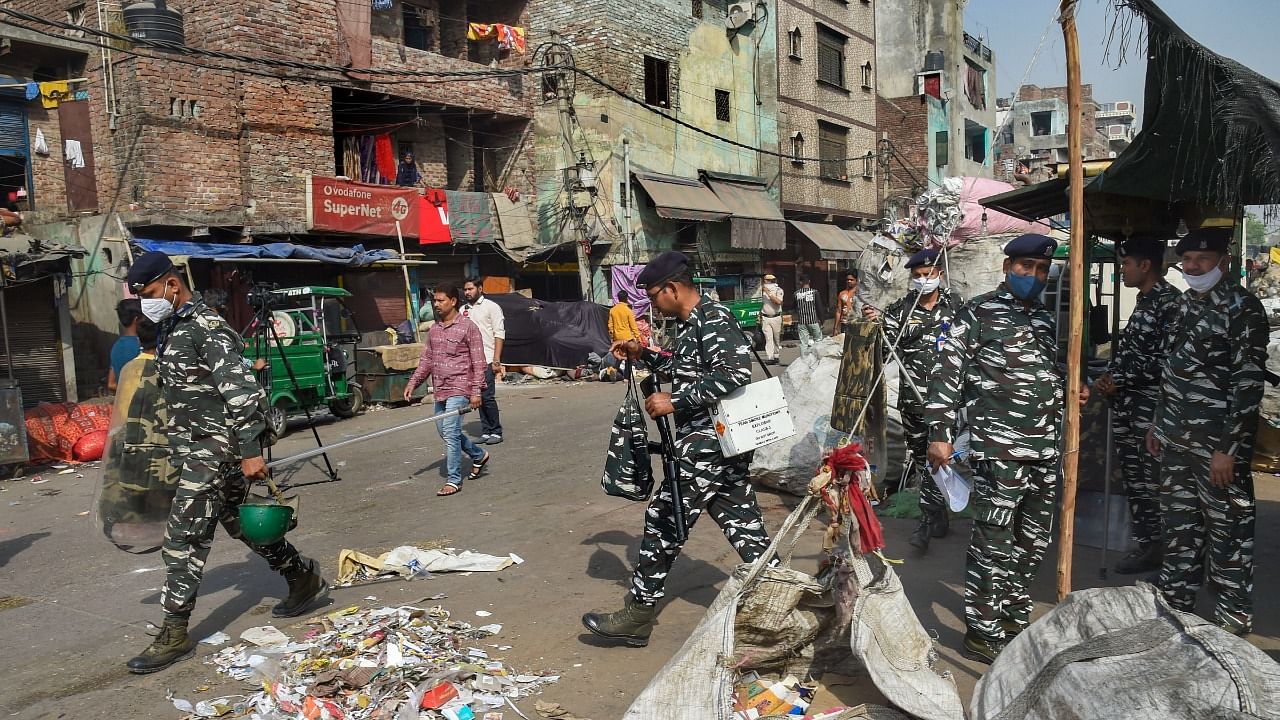 Security personnel keep vigil after clashes broke out between two communities during a Hanuman Jayanti procession on Saturday, at Jahangirpuri in New Delhi. Credit: PTI Photo