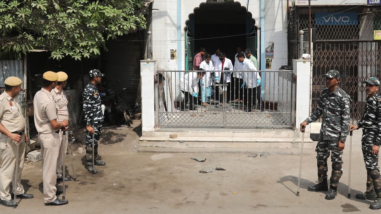 Forensic team investigate and collect samples from a mosque, after clashes broke out between two communities during a Hanuman Jayanti procession on Saturday, at Jahangirpuri in New Delhi. Credit: IANS Photo