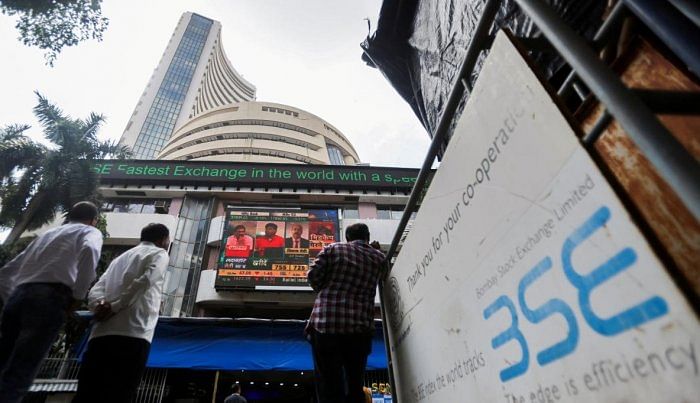 FILE PHOTO: People stand outside the Bombay Stock Exchange (BSE). Credit: Reuters