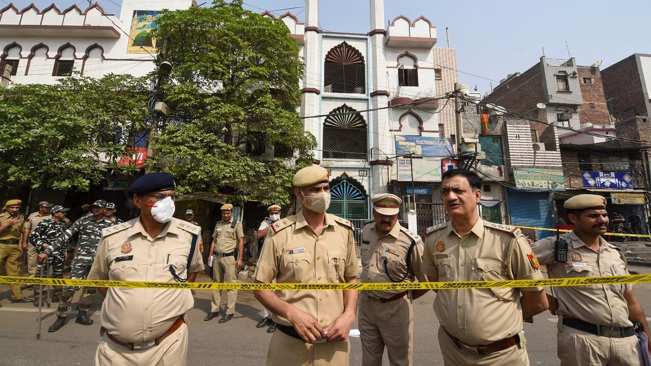 Security personnel keep vigil after clashes broke out between two communities during a Hanuman Jayanti procession on Saturday, at Jahangirpuri in New Delhi. Credit: PTI Photo