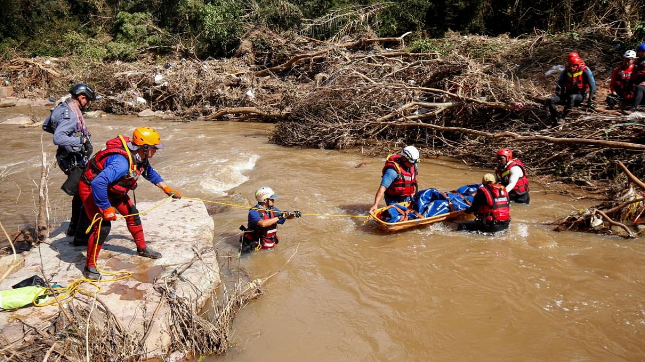 A search and rescue team prepares to airlift a body from the Mzinyathi River after heavy rains caused flooding near Durban. Credit: Reuters photo