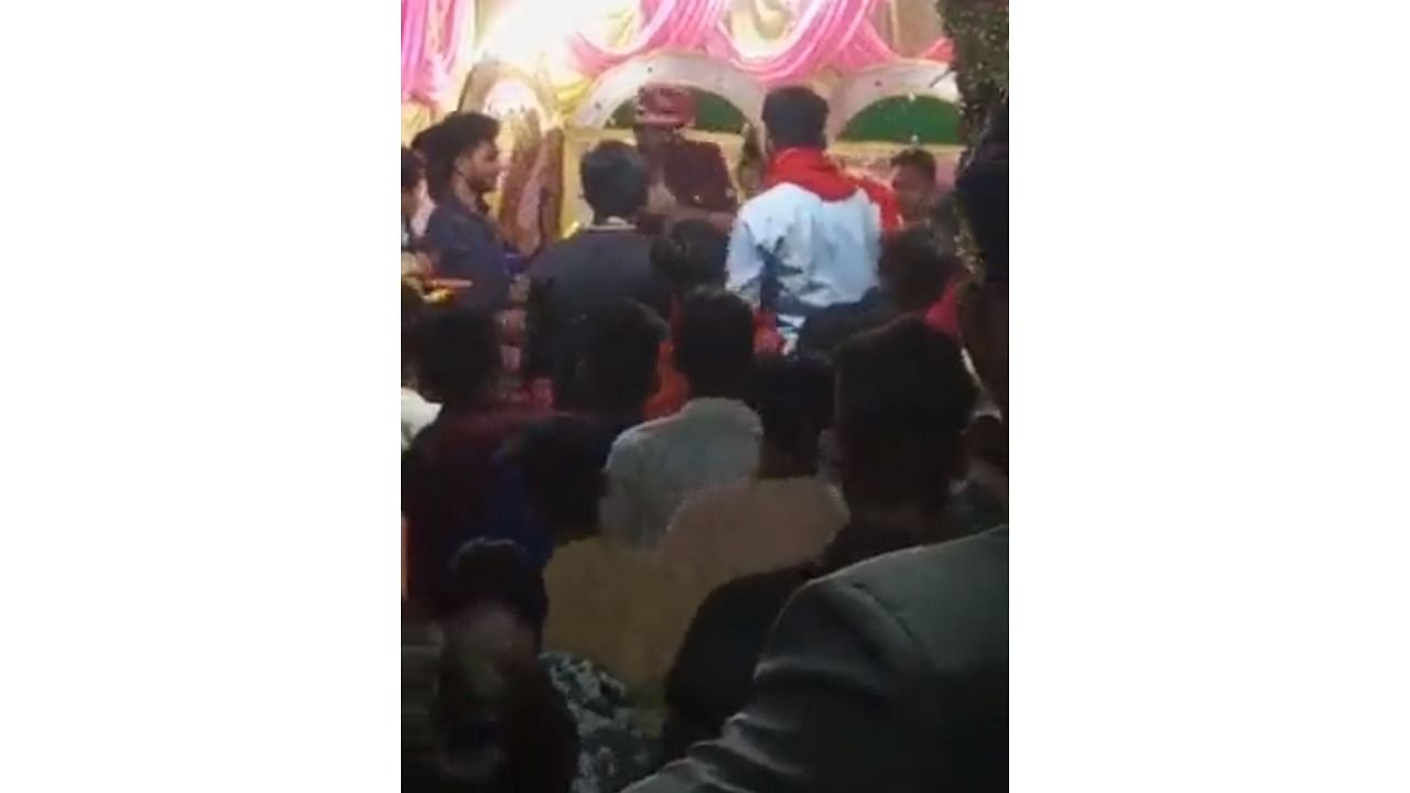 A screengrab from the viral video shows Reena slapping Ravikant. Credit: Twitter