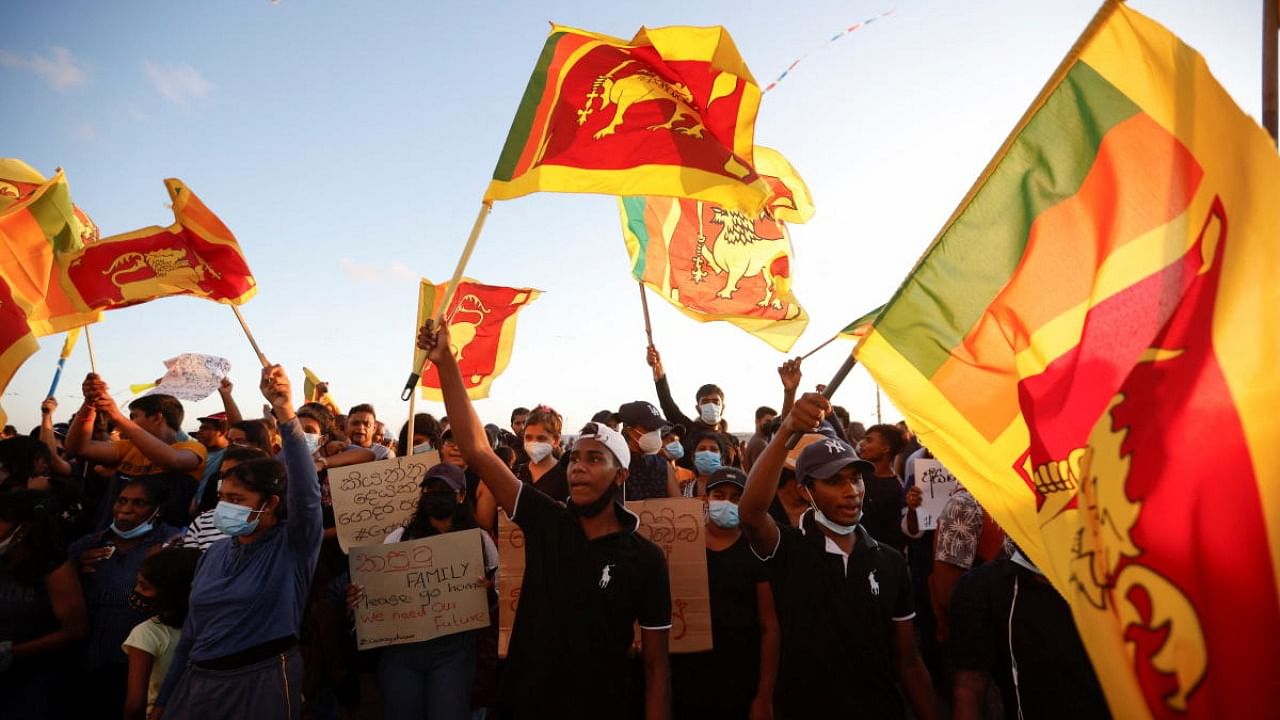 Demonstrators hold Sri Lankan national flags and shout slogans during a protest against Sri Lankan President Gotabaya Rajapaksa, near the Presidential Secretariat, amid the country's economic crisis, in Colombo. Credit: Reuters photo