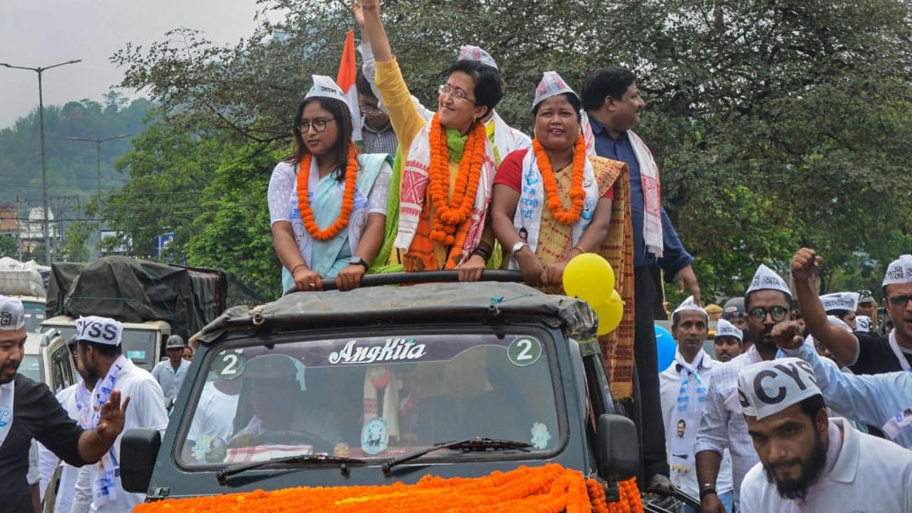  AAP MLA Atishi Singh waves at the people during a roadshow for the upcoming Guwahati Municipal Corporation (GMC) elections, in Guwahati, Wednesday, April 20, 2022. Credit: PTI Photo