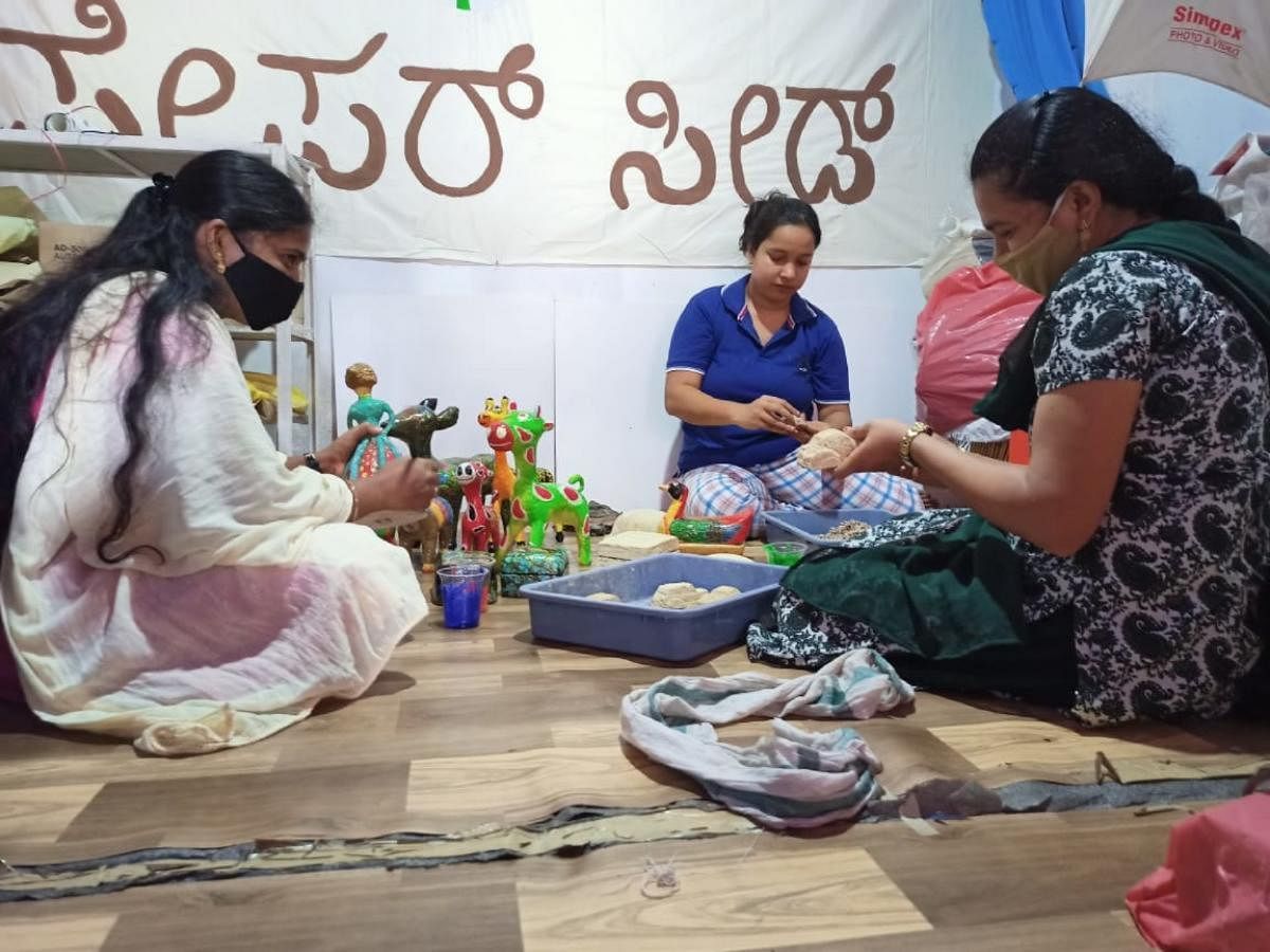 A file photo of women making toys from paper mache or paper pulp.