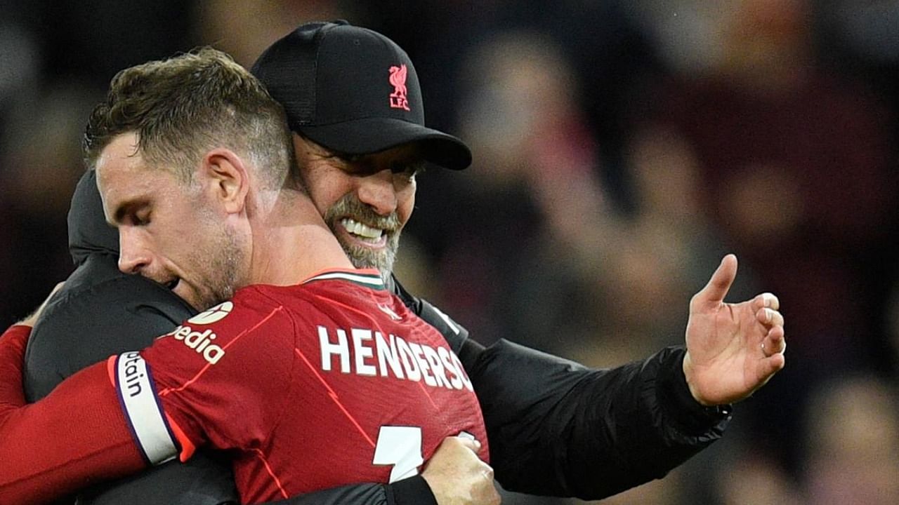 Liverpool's German manager Jurgen Klopp (L) congratulates with Liverpool's English midfielder Jordan Henderson (R) at the end of the English Premier League football match between Liverpool and Manchester United. Credit: AFP Photo