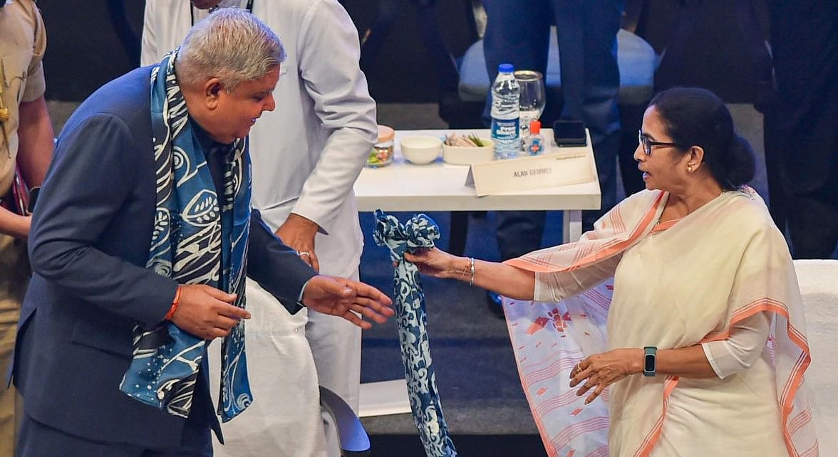 West Bengal Chief Minister Mamata Banerjee interacts with Governor Jagdeep Dhankar during the inauguration of 6th Bengal Global Business Summit (BGBS), in Kolkata, Wednesday, April 20, 2022. (PTI Photo/Swapan Mahapatra)