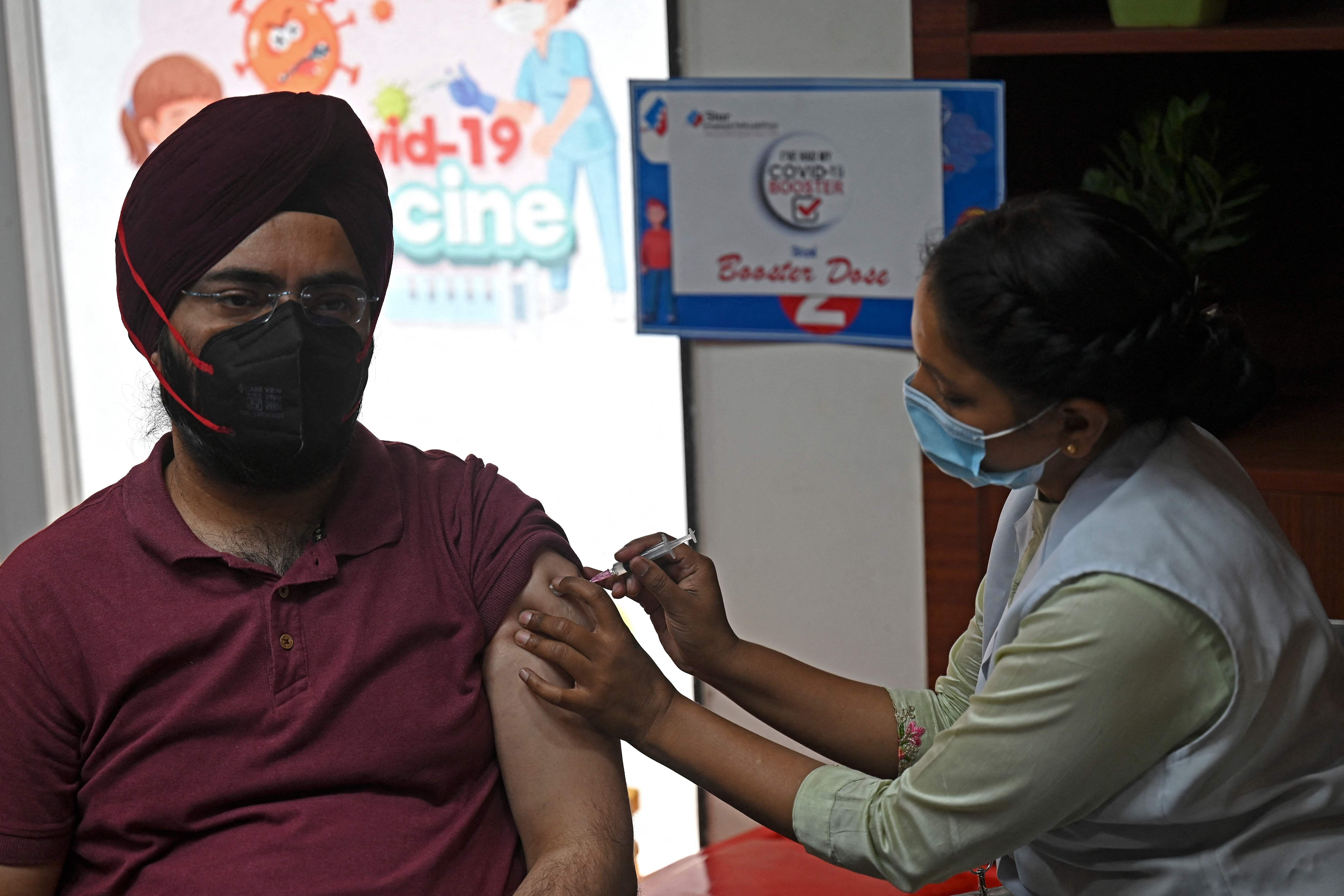 A health worker inoculates a man with a dose of the Covaxin vaccine against the Covid-19. Credit: AFP Photo