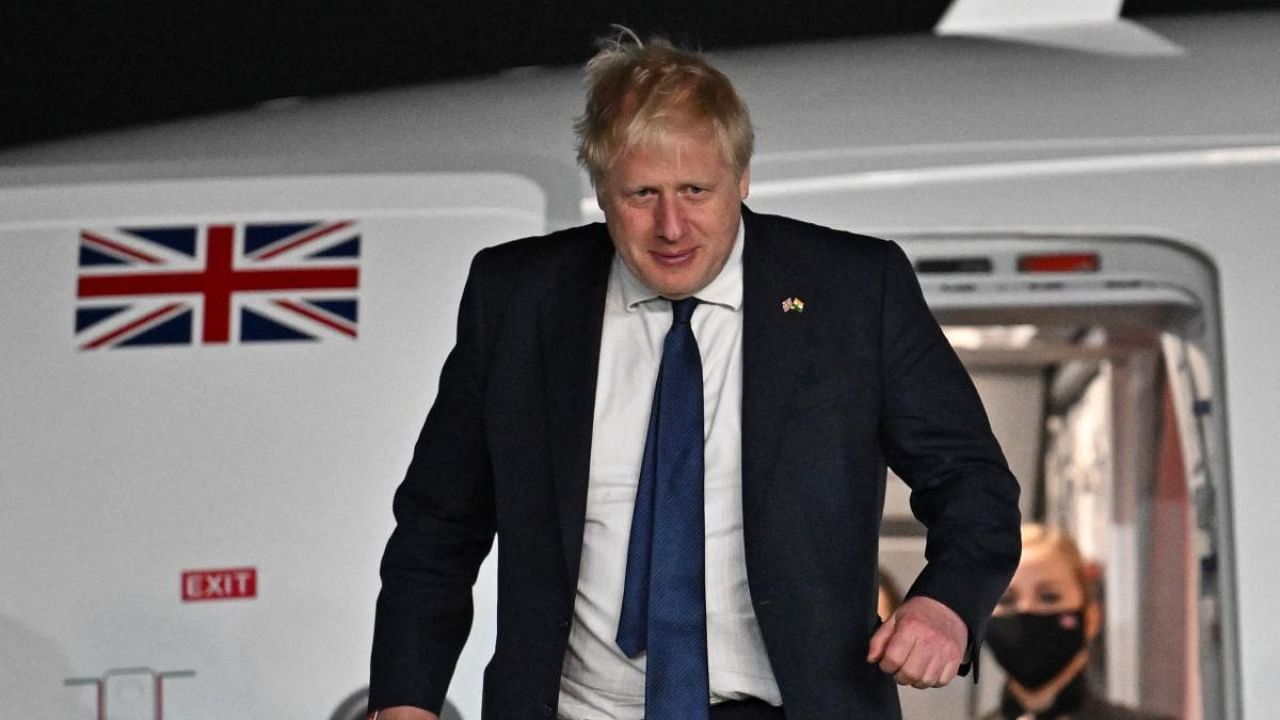 Britain's Prime Minister Boris Johnson disembarks the plane having arrived at Indira Gandhi International Airport in New Delhi. Credit: AFP Photo