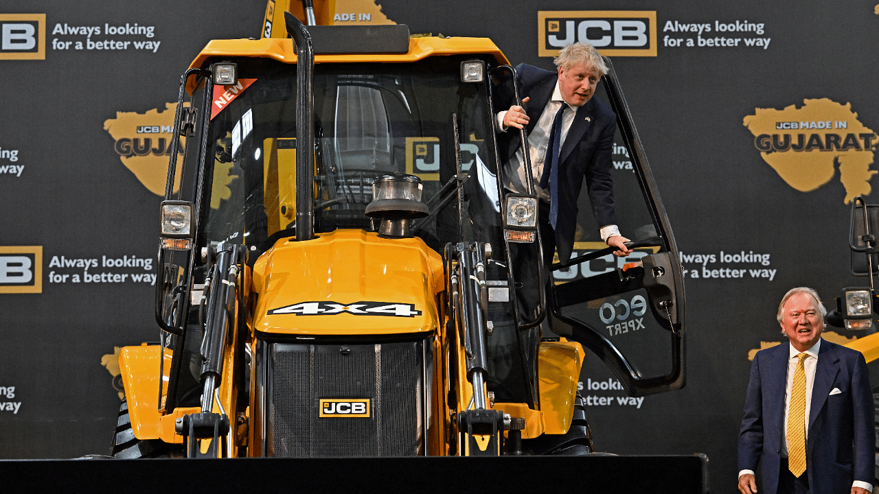 British Prime Minister Boris Johnson poses with Chairman of JCB Lord Bamford at the new JCB Factory. Credit: Reuters Photo