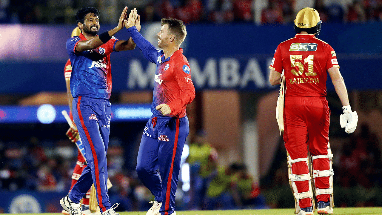 Khaleel Ahmed of Delhi Capitals celebrates with teammate David Warner after the wicket of Jonny Bairstow of Punjab Kings. Credit: PTI Photo