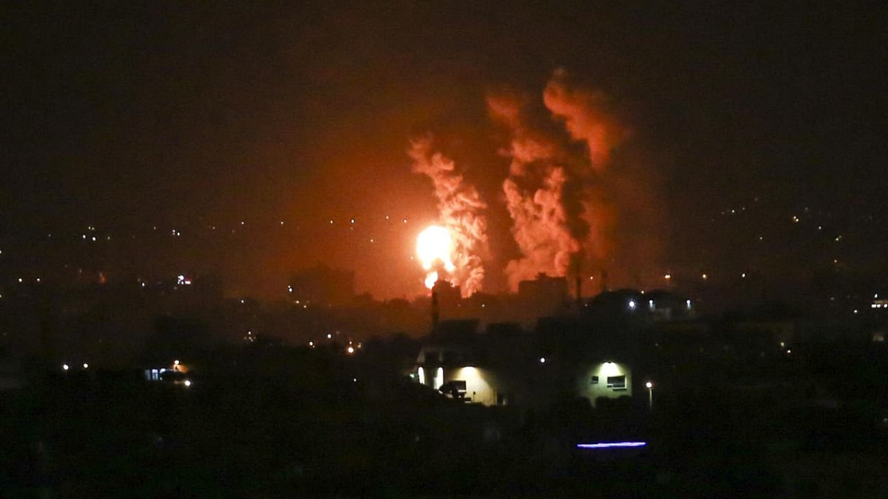 Flames and smoke rise during Israeli airstrikes central Gaza strip in on April 21, 2022. Credit: AFP Photo