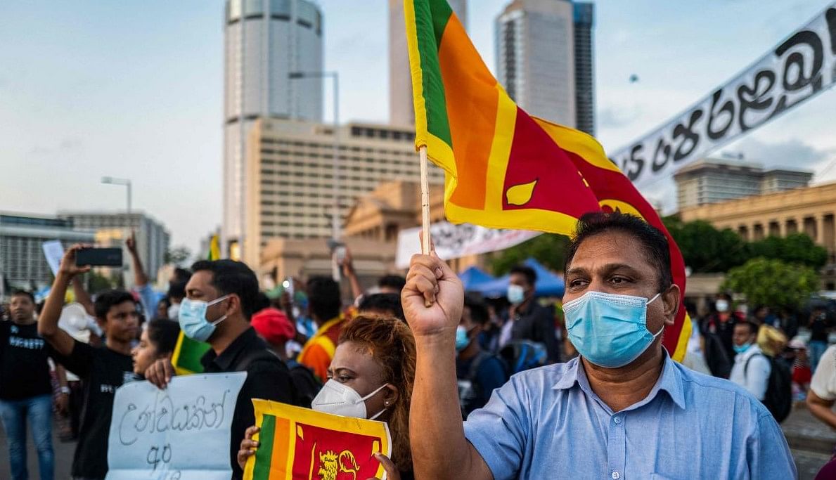 Protesters display placards during an ongoing anti-government demonstration near the president's office in Colombo on April 20, 2022, demanding President Gotabaya Rajapaksa’s resignation over the country's crippling economic crisis. Credit: AFP Photo