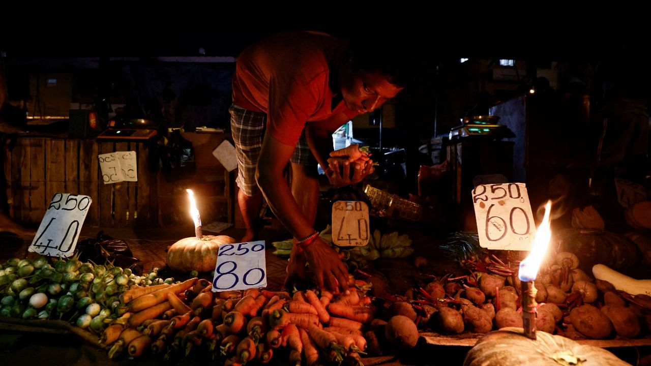 A vendor prepares a vegetables bag for a customer at the main market as the generator was broken, amid the country's economic crisis in Colombo, Sri Lanka. Credit: Reuters photo
