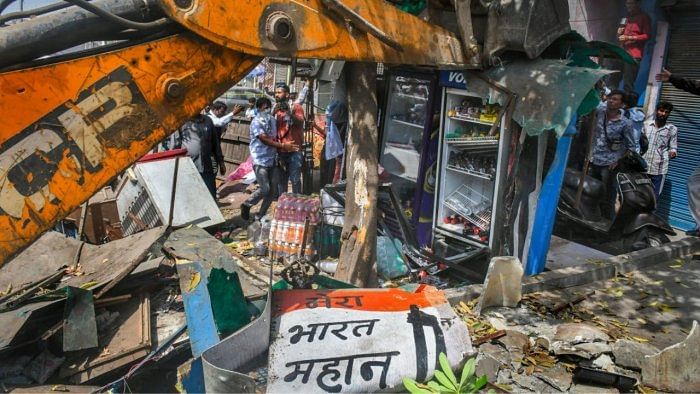 A bulldozer being used to demolish illegal structures during a joint anti-encroachment drive by NDMC, PWD, local bodies and the police, in the violence-hit Jahangirpuri area. Credit: PTI Photo