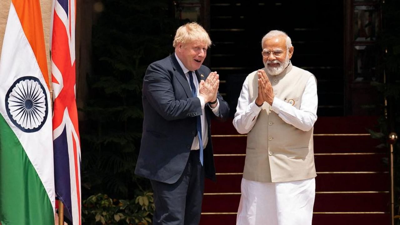 Britain's Prime Minister Boris Johnson (L) and his Indian counterpart Narendra Modi gesture before their meeting at Hyderabad House in New Delhi on April 22, 2022. Credit: AFP Photo