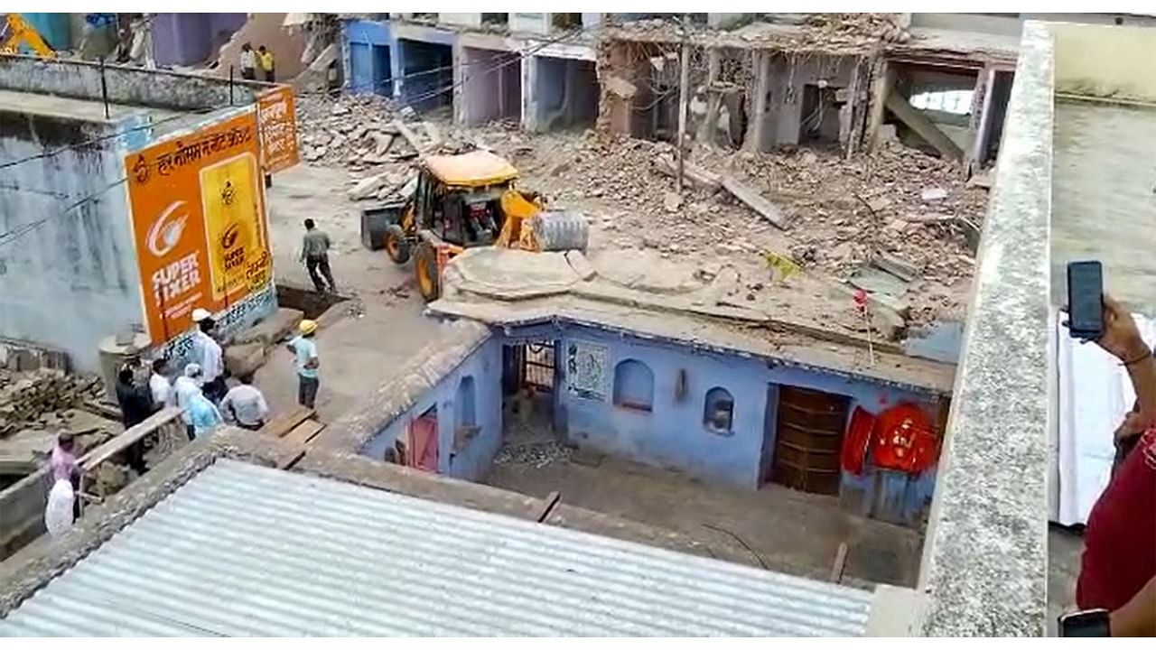 A bulldozer being used to demolish a 300-year-old Shiva temple at Sarai Mohalla, in Alwar district of Rajasthan. Credit: PTI Photo