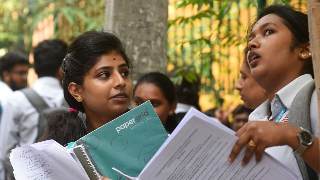 Students arrive to write the II PU examination at Seshadripuram college in Bengaluru on Friday. Credit: DH Photo/Pushkar V