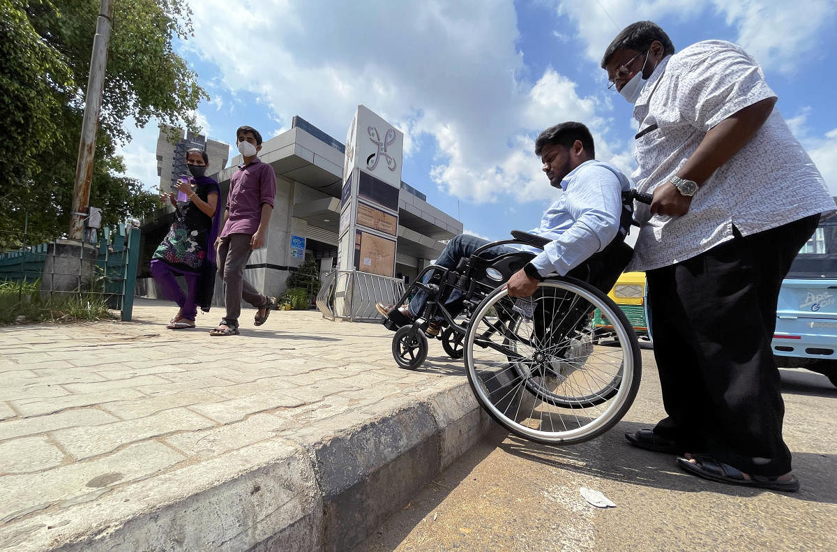 As his father and the driver got down to re-assemble his wheelchair, Imran scanned the premises for a ramp or lift to get inside. He spotted neither. Credit: DH Photo/Pushkar V