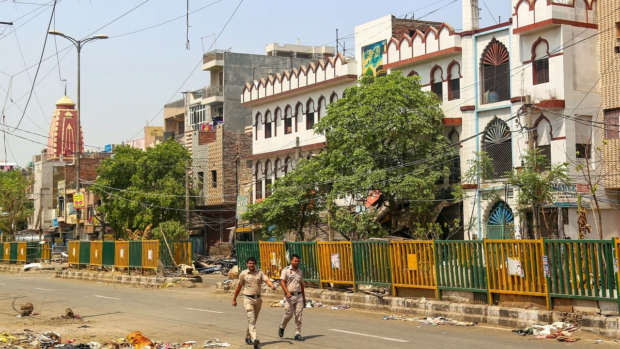 Policemen patrol in the violence-hit Jahangirpuri area. Credit: PTI Photo