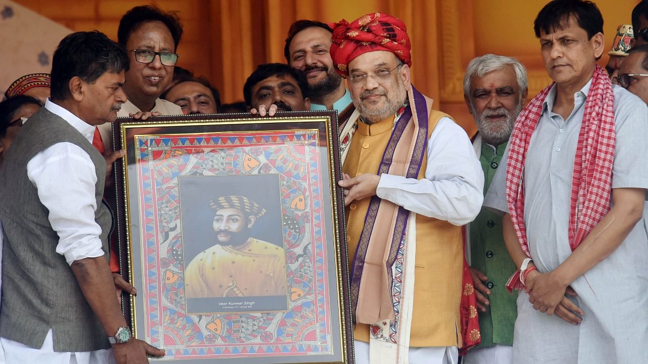 Union Home Minister Amit Shah being presented a portrait during Veer Kunwar Singh Vijayotsav at Jagdishpur. Credit: PTI Photo