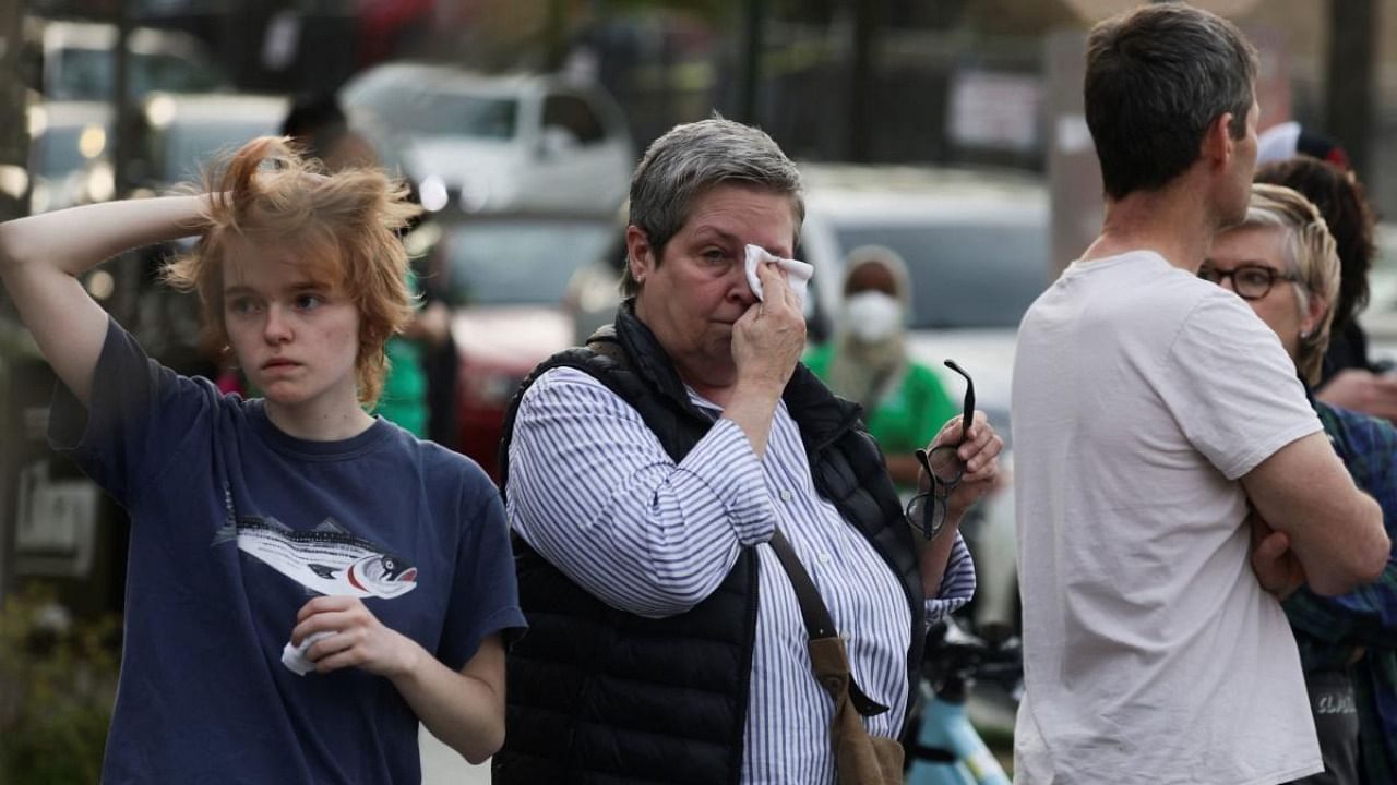 Family members wait to be reunited with schoolchildren near scene of reported shooting near the Edmund Burke School in Washington. Credit: Reuters photo