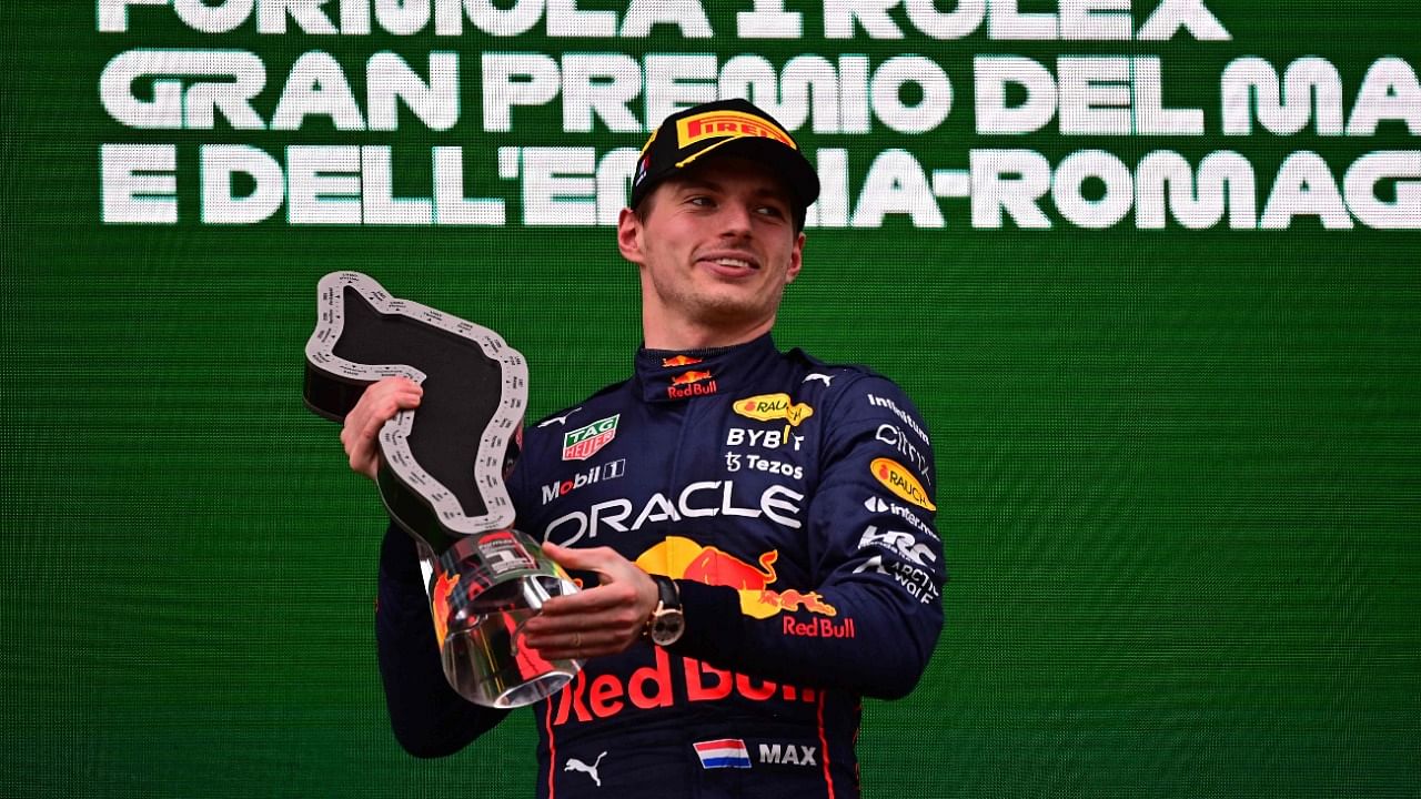 Red Bull Racing's Dutch driver Max Verstappen holds the winner's trophy as he celebrates on the podium after the Emilia Romagna Formula One Grand Prix at the Autodromo Internazionale Enzo e Dino Ferrari race track in Imola. Credit: AFP Photo