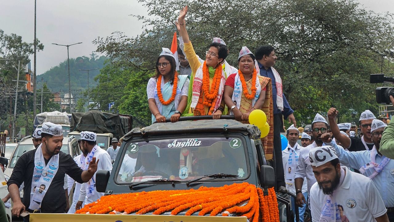 AAP MLA Atishi Singh waves to the public during a roadshow in the run-up to the Guwahati Municipal Corporation polls. Credit: PTI Photo