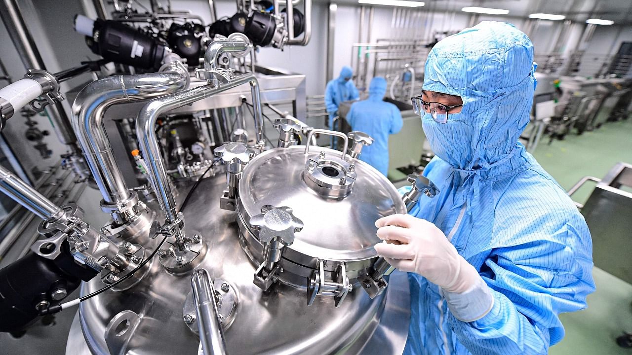 An employee works at a facility producing a Covid-19 coronavirus vaccine. Credit: AFP Photo