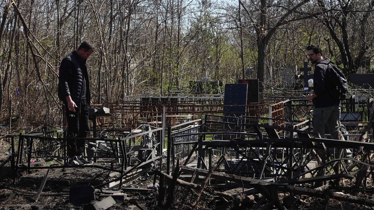 Local residents look at damaged graves in a cemetery of Odessa, southern Ukraine. Credit: AFP Photo