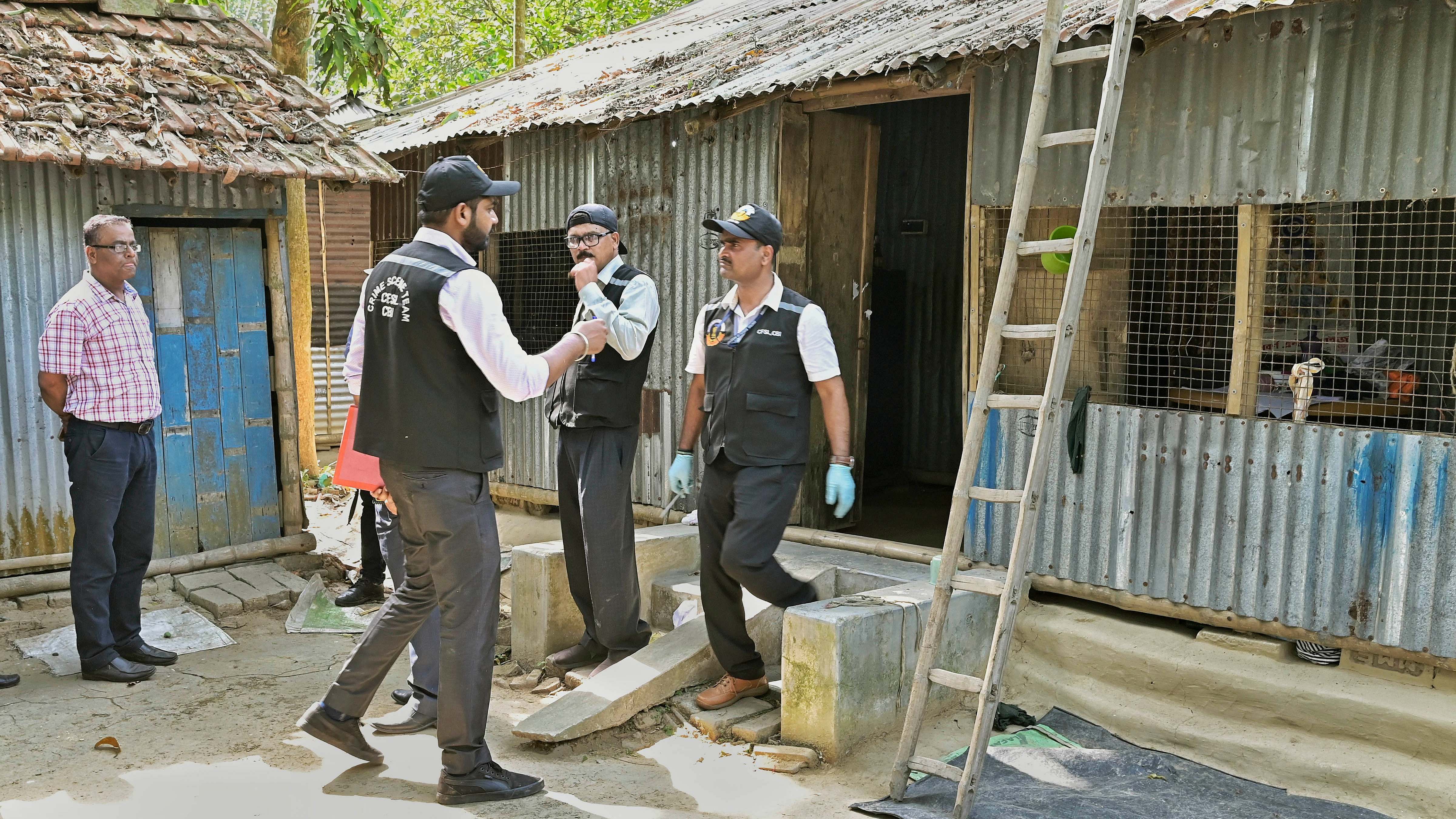 Forensic experts of CBI collect evidences for investigation at the residence of a prime accused in the Hanskhali rape and murder case, in Nadia. Credit: PTI Photo