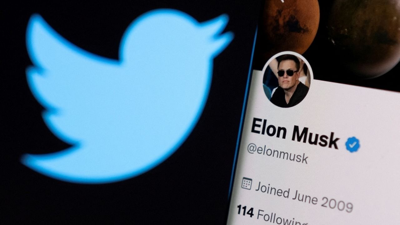 Elon Musk's twitter account is seen on a smartphone in front of the Twitter logo in this photo illustration. Credit: Reuters Photo