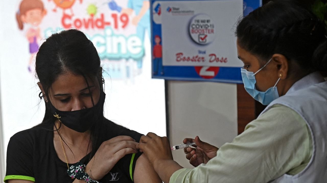 A health worker inoculates a girl with a dose of the Covaxin vaccine against the Covid-19. Credit: AFP Photo