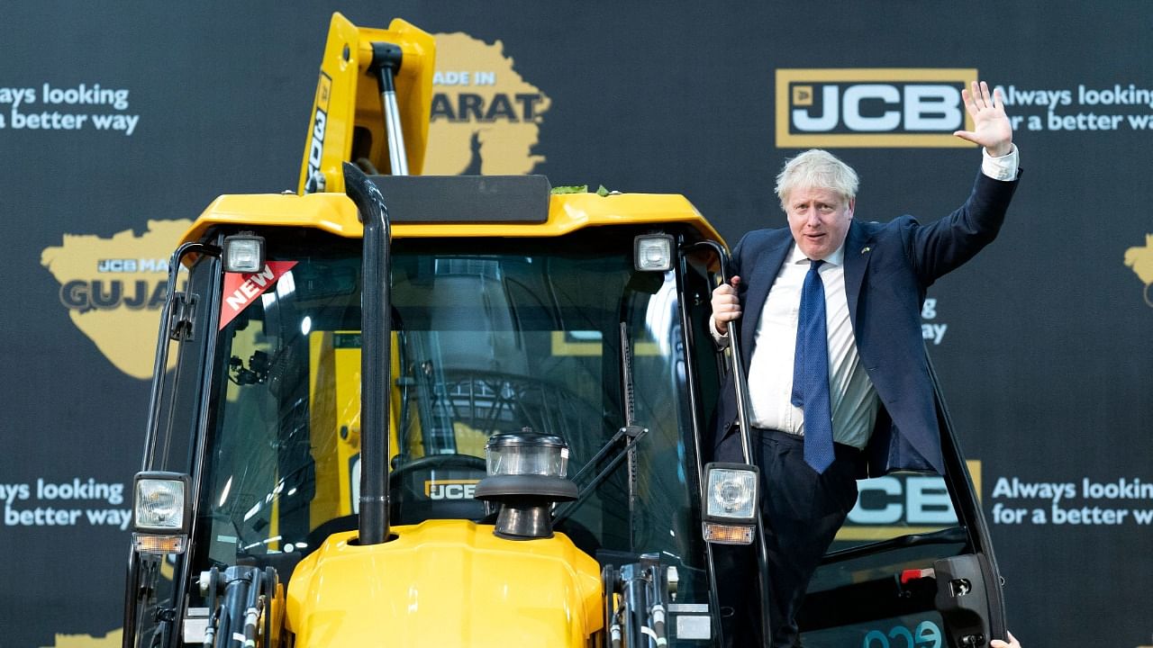 UK PM Boris Johnson hopped on a bulldozer around the same time the machine was used to raze down homes in Delhi's Jahangirpuri. Credit: AFP File Photo