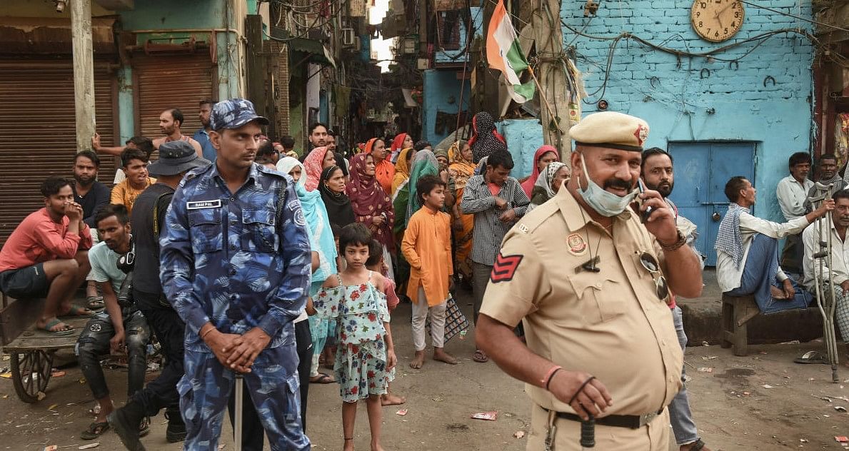 Security personnel during a 'Tiranga Yatra' taken out by members of both Hindu and Muslim communities, at the communal violence-hit Jahangirpuri area, in New Delhi. Credit: PTI