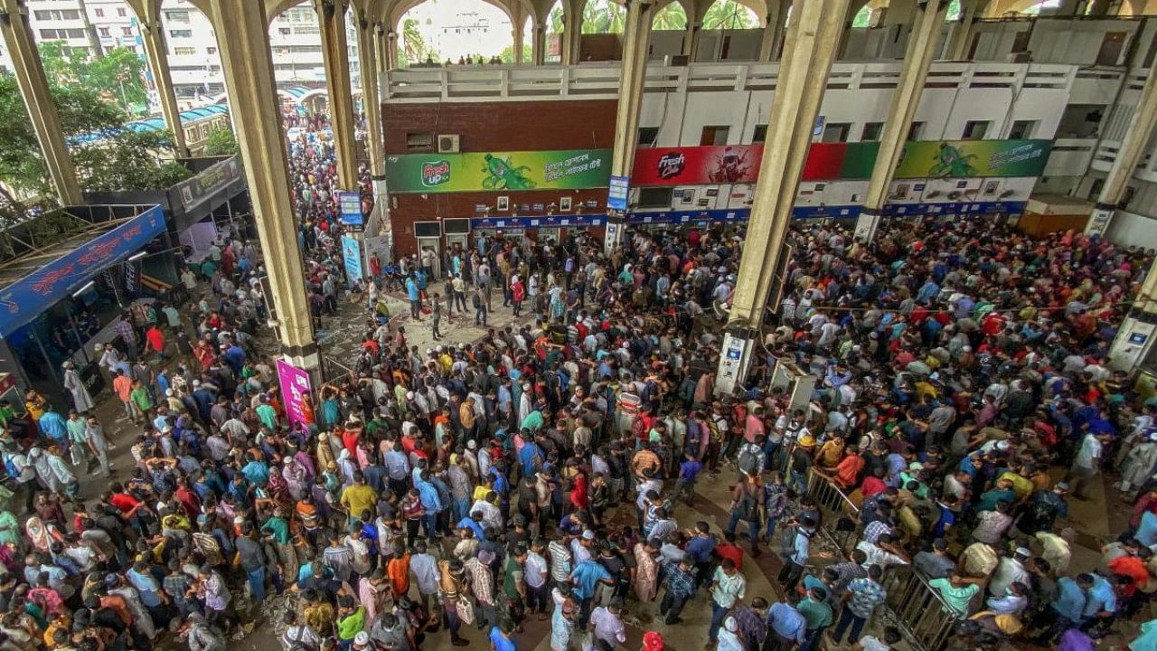 People crowd at a railway station to buy advance tickets to travel to their native places to celebrate Eid al-Fitr, which marks the end of the Muslim's holy festival of Ramadan in Dhaka. Credit: AFP Photo