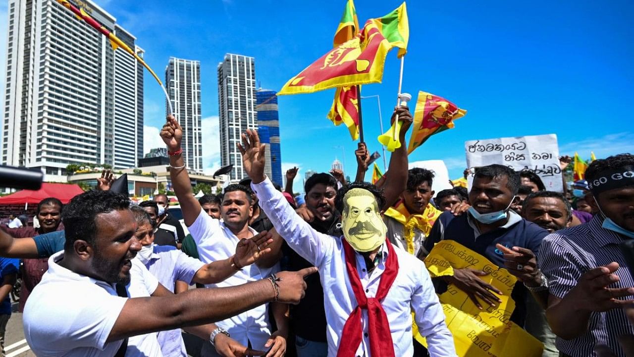 Protestors participate in an ongoing anti-government demonstration outside the President's office in Colombo. Credit: AFP Photo
