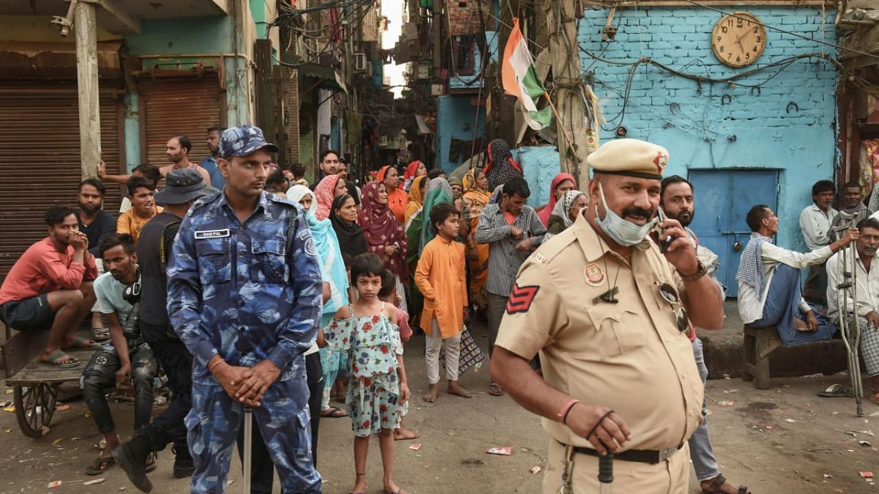 Security personnel during a 'Tiranga Yatra' taken out by members of both Hindu and Muslim communities, at the communal violence-hit Jahangirpuri area, in New Delhi. Credit: PTI file photo