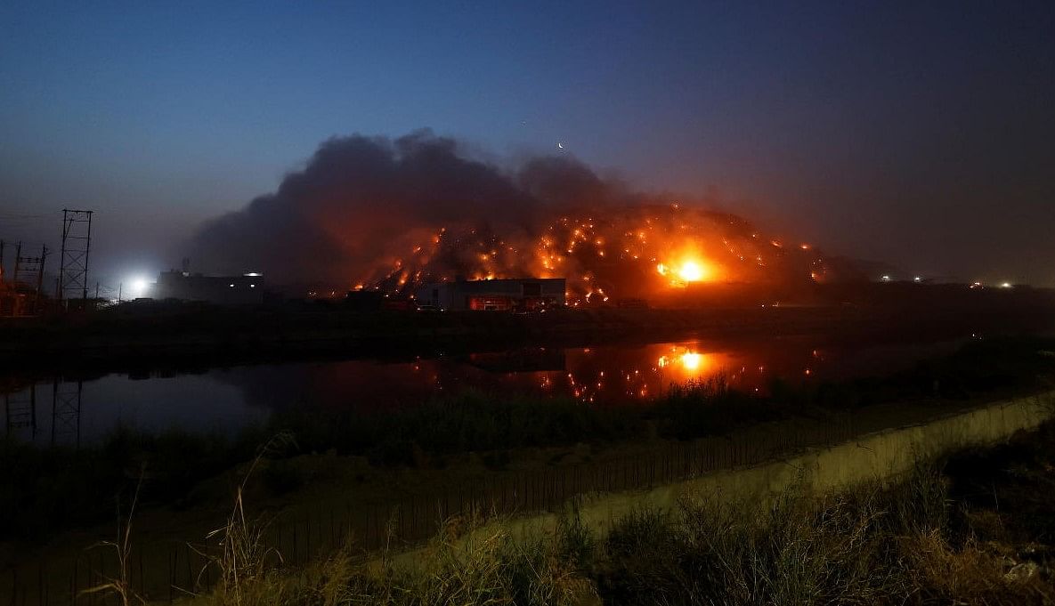 Smoke billows from burning garbage at the Bhalswa landfill site in New Delhi. Credit: Reuters