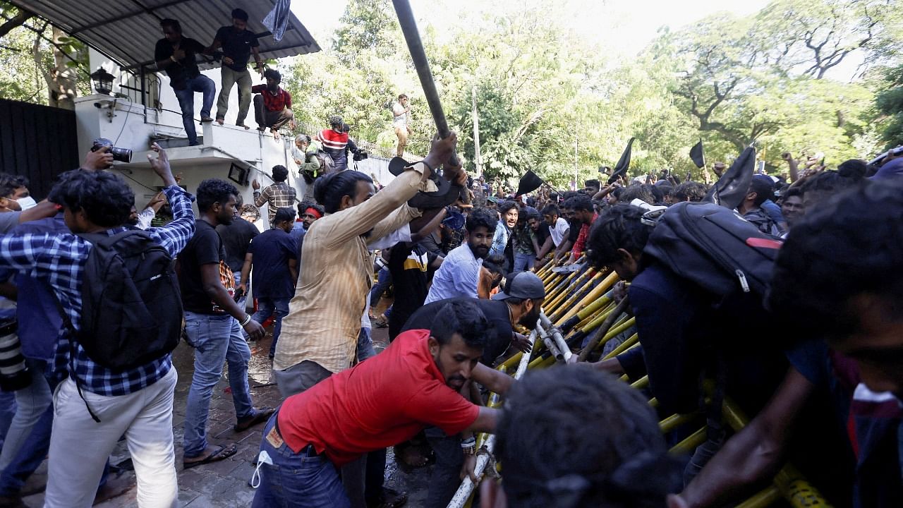 Demonstrators pull barricades outside the Sri Lankan Prime Minister Mahinda Rajapaksa's residence during the protest, amid the country's economic crisis, in Colombo, Sri Lanka. Credit: Reuters Photo