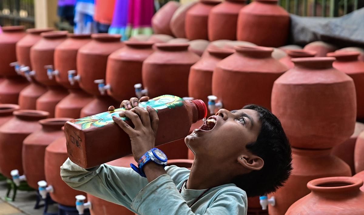 A boy quenches his thirst on a hot summer day. Credit: DH File Photo