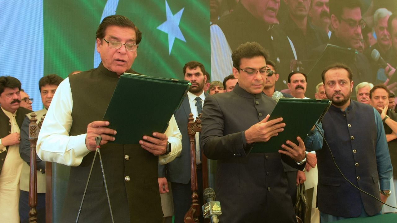 Speaker of the national assembly, Raja Pervez Ashraf (L) administering the oath to Hamza Shehbaz Sharif (C), son of Pakistan's Prime Minister Shehbaz Sharif as the chief minister of Punjab province in Lahore. Credit: AFP Photo