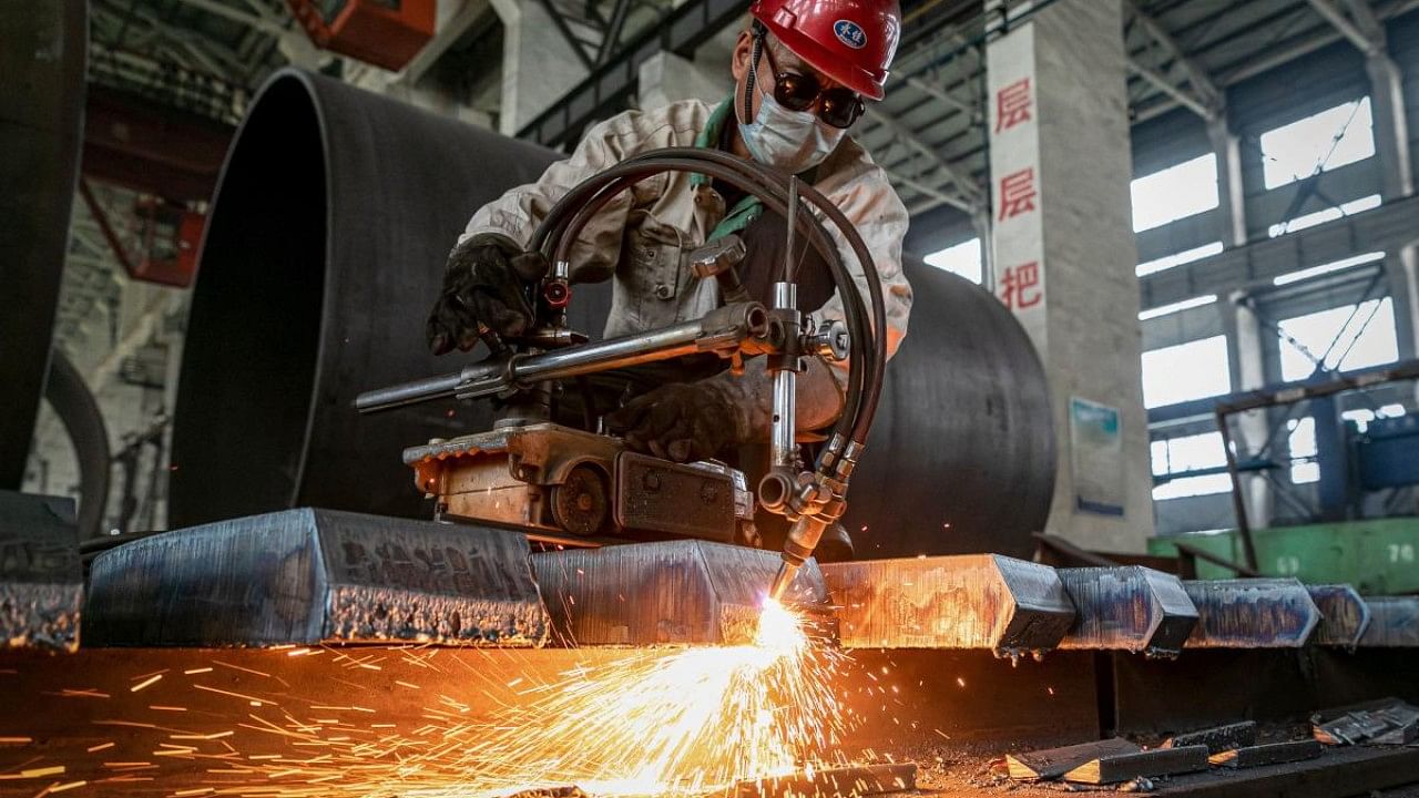 A worker produces manufacturing machinery at a factory in Nantong, in China's eastern Jiangsu province. Credit: AFP File Photo