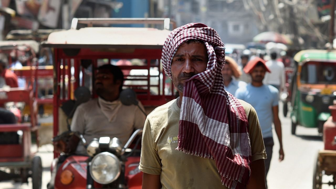 A man covers himself with a scarf on a hot summer day, in Old Delhi. Credit: PTI Photo