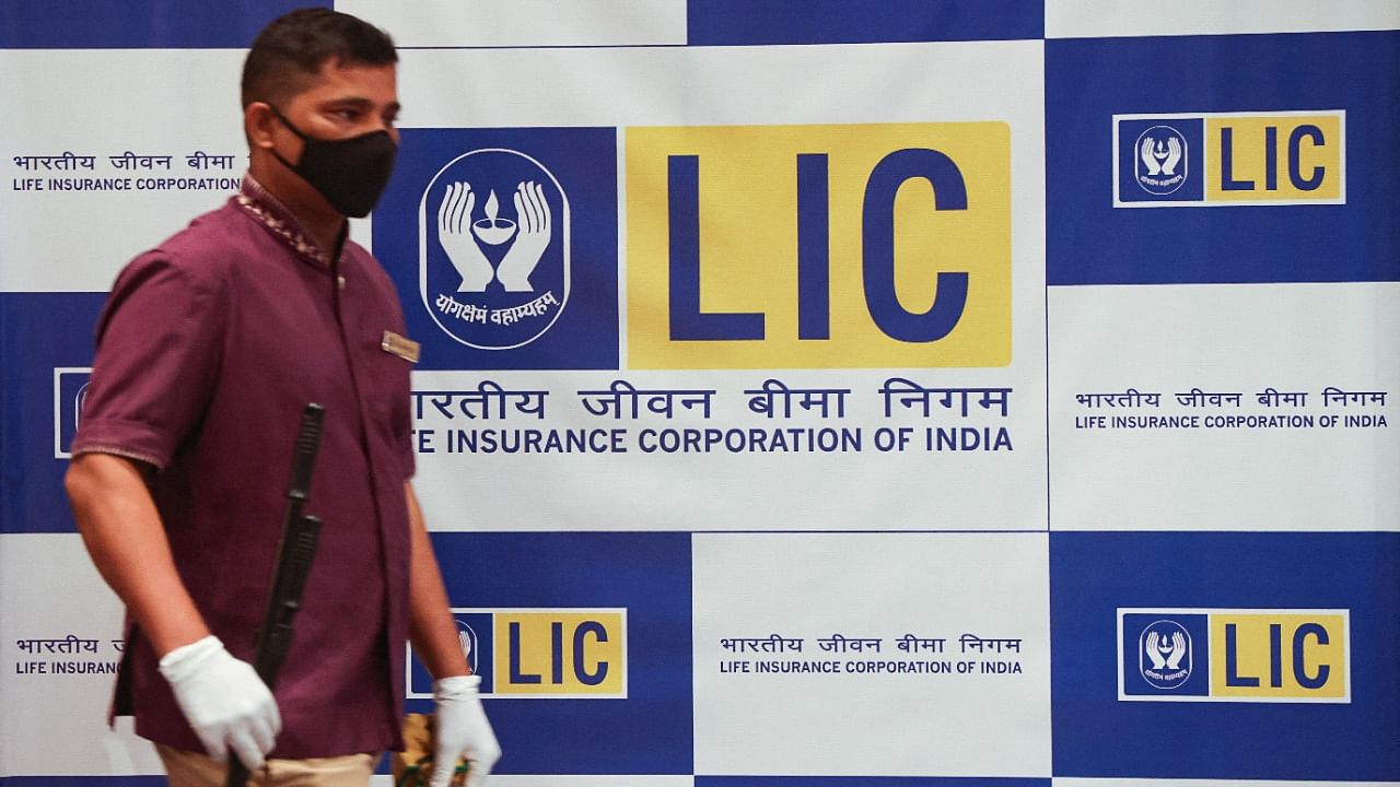 A man walks past a hoarding of Life Insurance Corporation of India (LIC). Credit: Reuters Photo