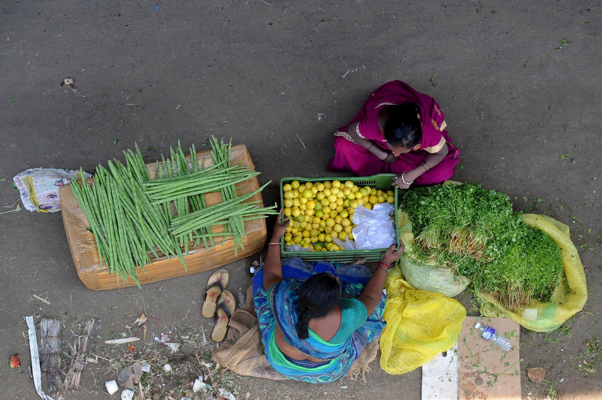 A woman sells vegetables near KR Market in Bengaluru. Credit: DH Photo/ Pushkar V