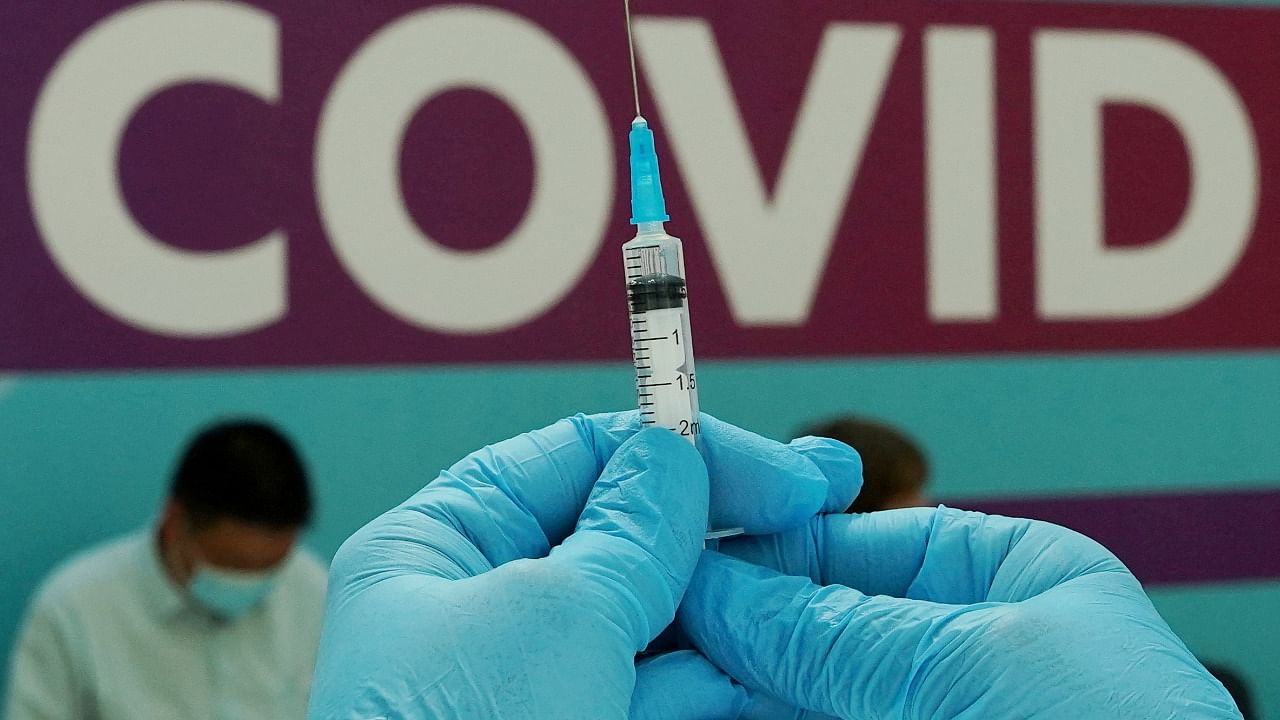 A healthcare worker prepares a dose of Sputnik V Covid vaccine. Credit: Reuters Photo