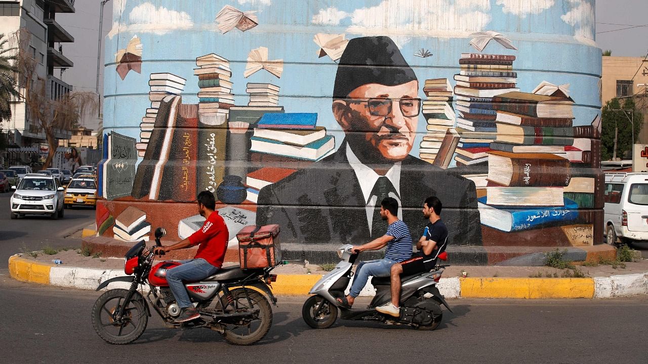 A picture shows a mural of Iraqi author Ali al-Wardi, drawn by Iraqi painter Wijdan al-Majed, on a concrete structure in the capital Baghdad. Credit: AFP Photo